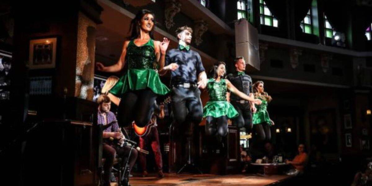 Irish dancers in green dazzle the Disney Springs stage, joined by live musicians and Irish Festival energy thrilling the crowd.