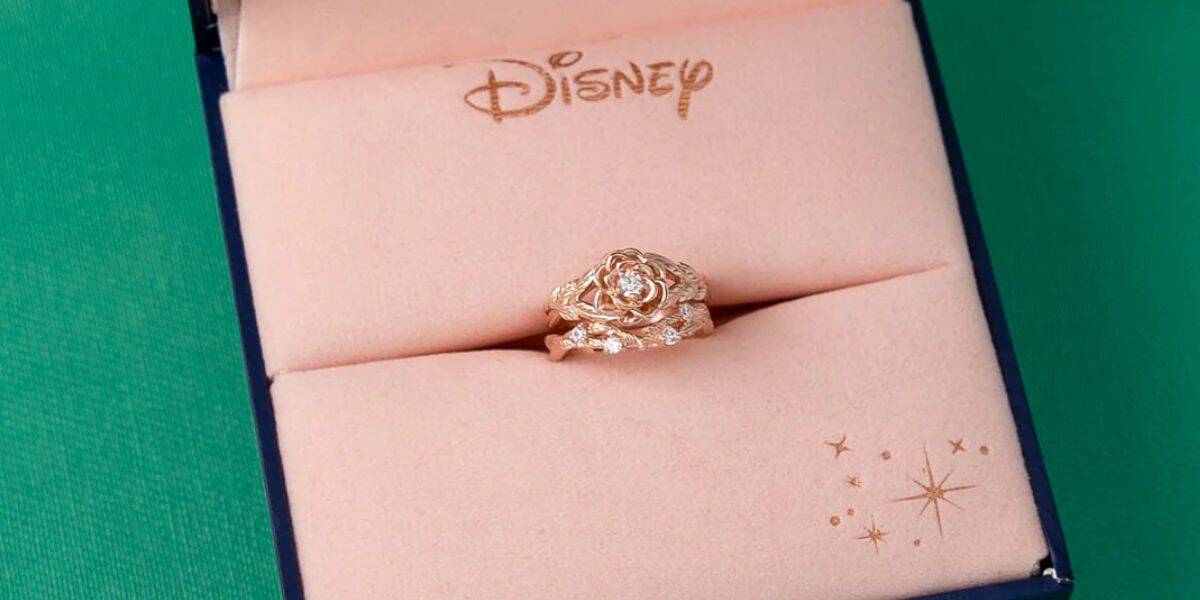 A gold rose ring in a pink Disney jewelry box