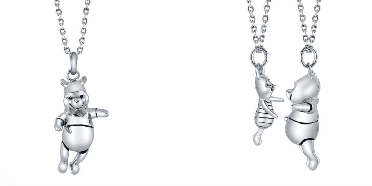 A Pooh necklace shown interacting with a Piglet necklace