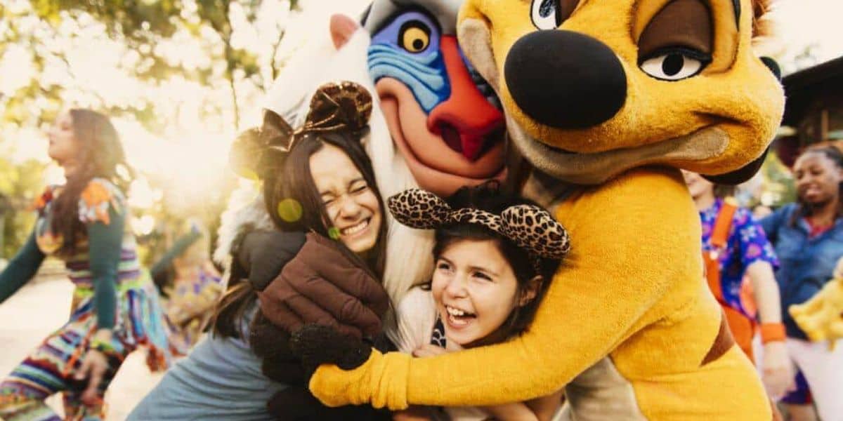 Timon and Rafiki from 'The Lion King' hug guests at Disney's Animal Kingdom Theme Park.