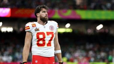 Travis Kelce, wearing his white Chiefs jersey #87, takes the field like a superstar at the big game.