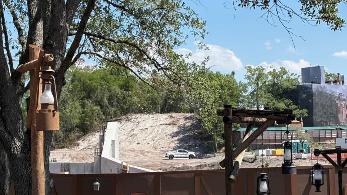 Piston Peak construction at Magic Kingdom features dirt mounds, lanterns, and new walls dividing it from Big Thunder Mountain Railroad.