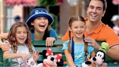 a Disney World family inside the parks with Minnie and Goofy stuffed animals