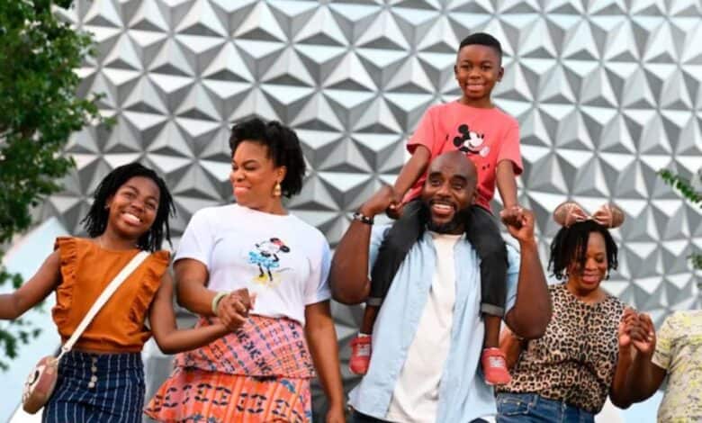 family in front of spaceship earth in disney world's epcot park