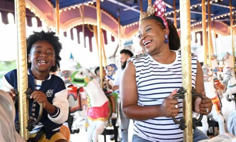 a mom and her son ride the prince charming carousel in disney world's magic kingdom park