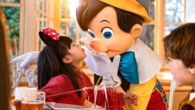 A child gives Pinocchio a kiss at Plaza Gardens