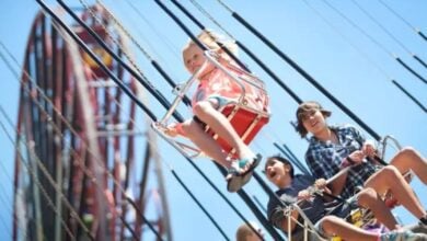 Kids laugh and soar on the Silly Symphony Swings. Six Flags Over Georgia ride stopped