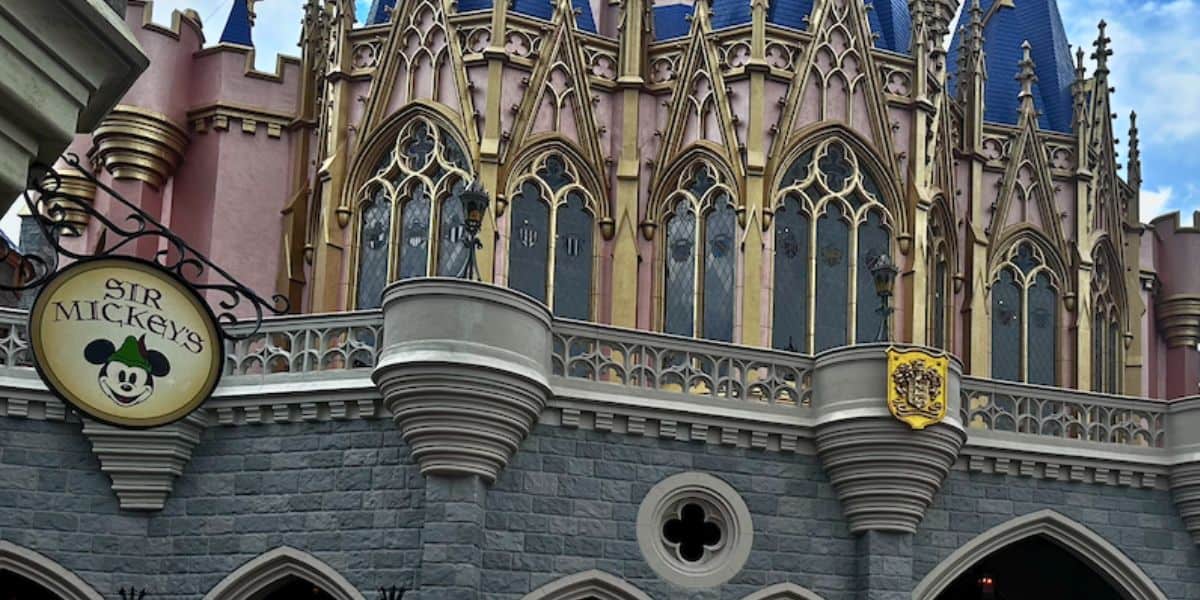 Sir Mickey’s at Disney World: a whimsical Gothic castle facade with ornate windows and crest above the shop’s welcoming archway.