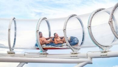Two people riding AquaMouse on a Disney Cruise Line ship, either the Disney Wish, Disney Treasure, or Disney Destiny