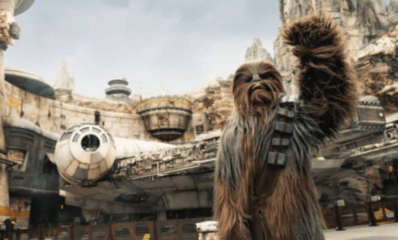 Chewy in front of Millennium Falcon: Smugglers Run in Disney's Galaxy's Edge