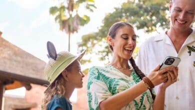 family uses phone at Disney World