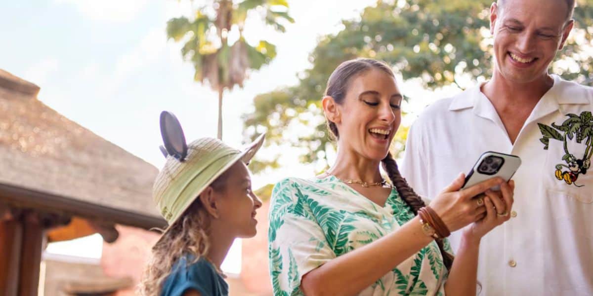 family uses phone at Disney World