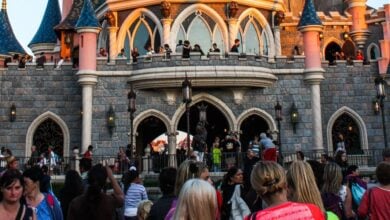 Visitors at the base of Sleeping Beauty Castle at Disneyland Paris.