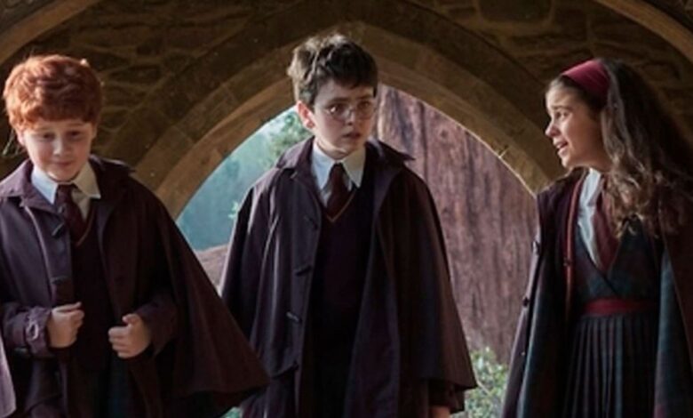 Harry (Dominic McLaughlin), Ron (Alastair Stout), and Hermione (Arabella Stanton) in their Hogwarts robes