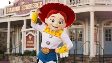 Jessie in front of Magic Kingdom's Diamond Horseshoe at Disney World
