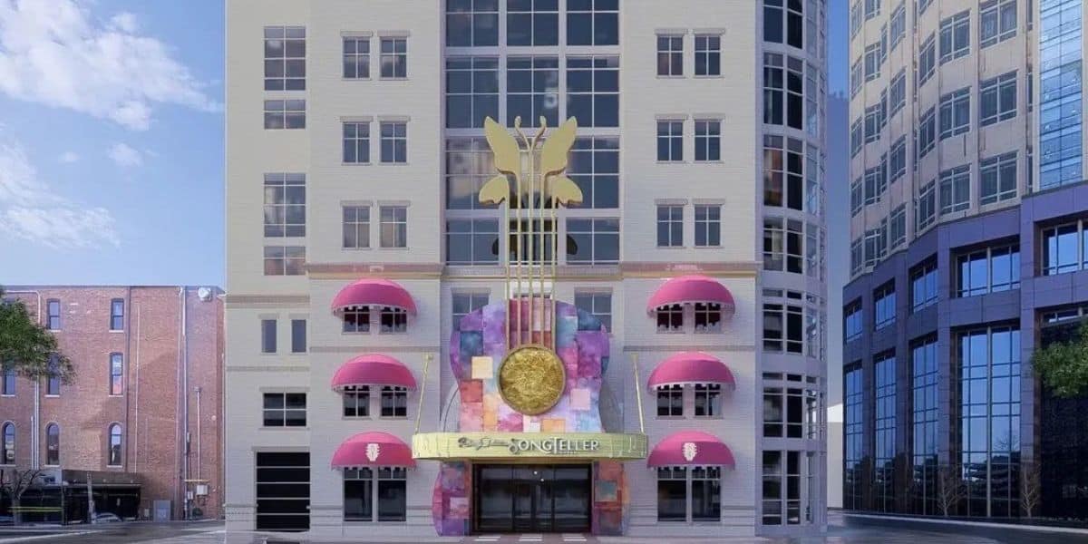 Song Hotel’s vibrant façade features playful pink awnings and a giant gold guitar, welcoming guests like a themed attraction.