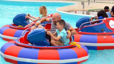 Families enjoy laughter and excitement on vibrant bumper boats at the water park, making memories together on every splash.