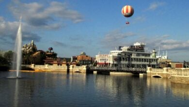 A hot air balloon soars above the water at Disney Springs.