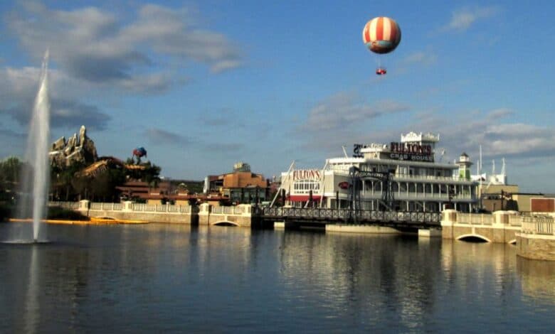 A hot air balloon soars above the water at Disney Springs.