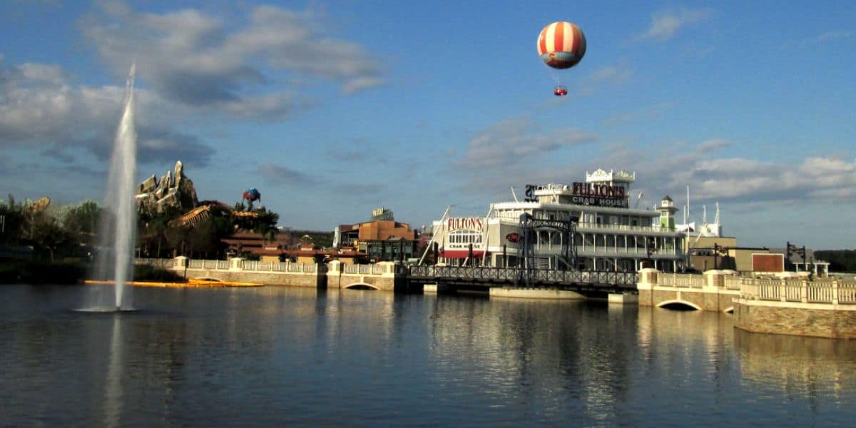 A hot air balloon soars above the water at Disney Springs.