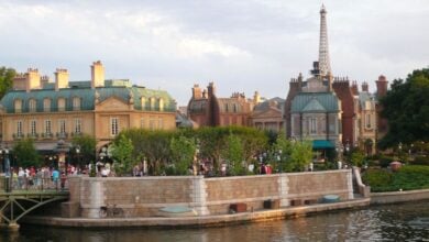 Guests walk by the International Gateway near the France EPCOT World Showcase Pavilion