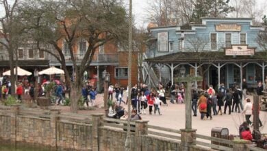 Guests stroll through Frontierland at Disneyland Paris