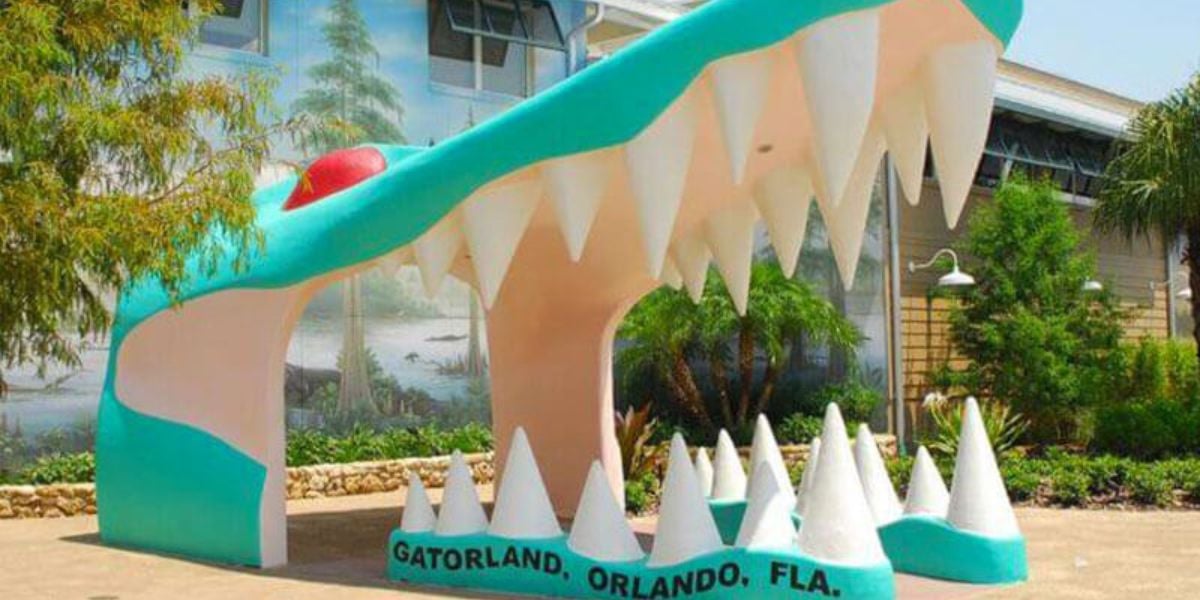 Iconic Gatorland entrance featuring the giant cartoon alligator mouth with massive white teeth and a bright red tongue.