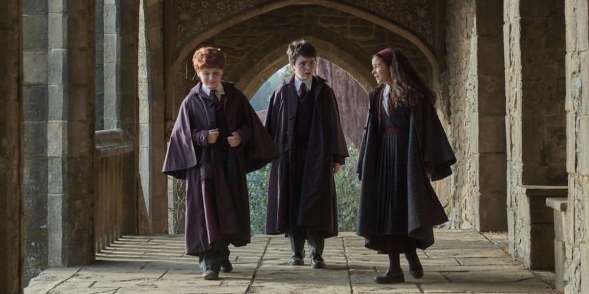 Harry, Ron, and Hermione in the halls of Hogwarts