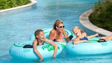 Guests enjoy a fun float on inner tubes in the lazy river at a Disney Springs resort, smiling and soaking up the family-friendly vibes.