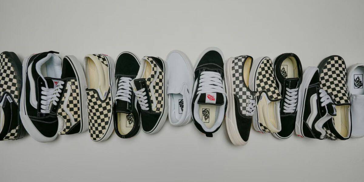 A lineup of black, white, and checkered Vans sneakers ready for Disney Springs visitors to grab before the next park adventure.