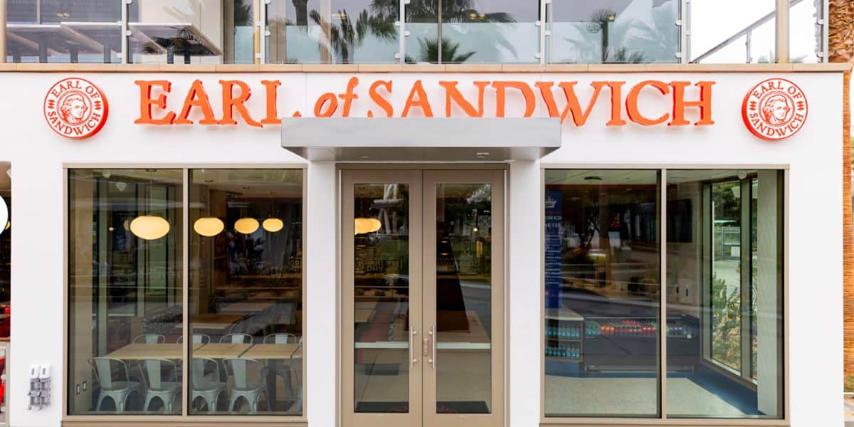 Earl of Sandwich at Downtown Disney, featuring its signature orange sign and glass entrance steps from Disneyland’s main gates.