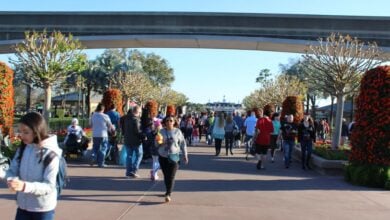 EPCOT guests stroll beneath the elevated monorail tracks