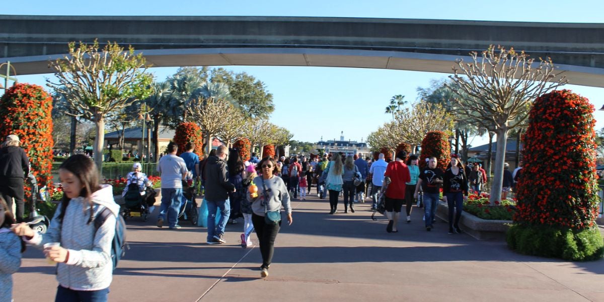 EPCOT guests stroll beneath the elevated monorail tracks