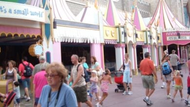 Guests stroll by "it's a small world" at Magic Kingdom Park