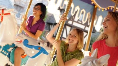 Guests riding the King Arthur Carrousel at Disneyland Park