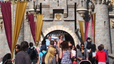 Guests walking through Sleeping Beauty Castle at Disneyland.