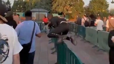 A guest leaps over a barrier at Disneyland Paris