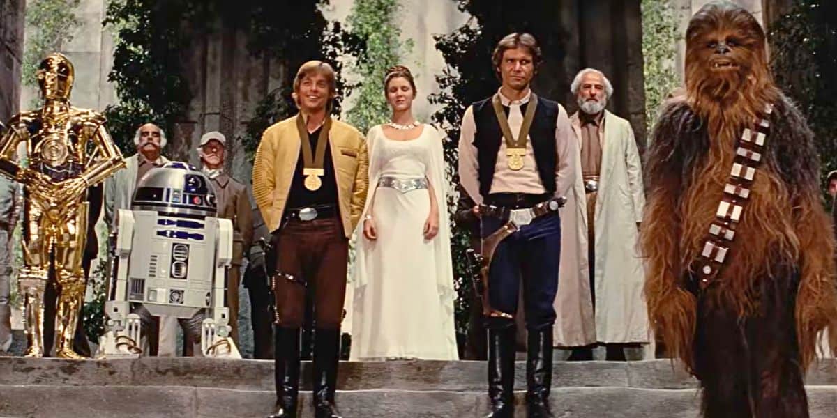 Luke Skywalker, Han Solo, Princess Leia, Chewbacca, and droids C-3PO and R2-D2 gather at the end of 'A New Hope'
