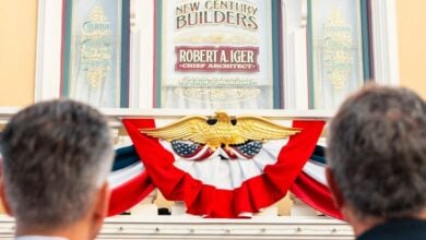 Guests admire a building sign honoring Robert A. Iger, set above a patriotic eagle and festive bunting, capturing the spirit of Disney’s legacy and leadership.