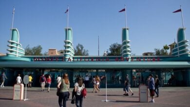 Guests stroll toward the iconic entrance of Disney California Adventure Park