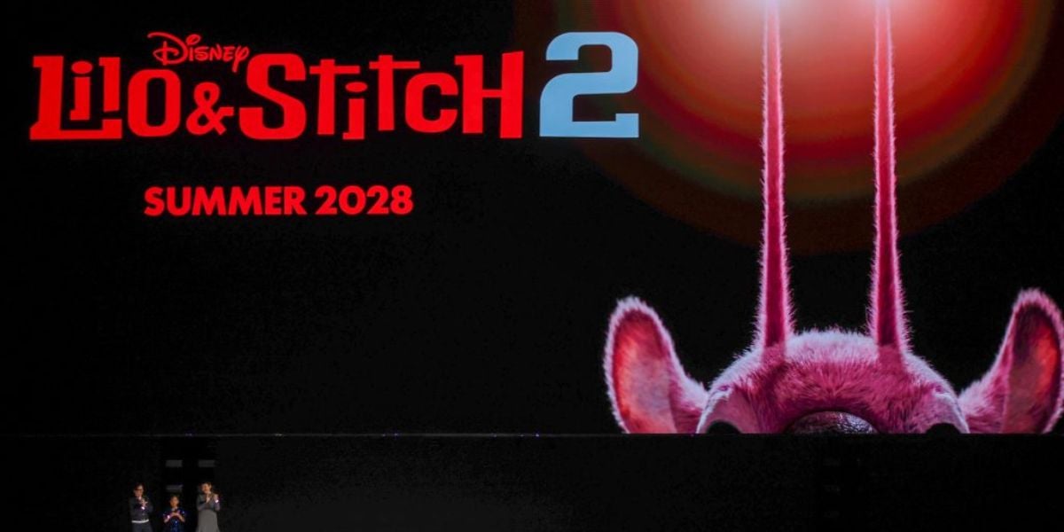 Lilo & Stitch 2 movie title displayed with Stitch’s iconic ears and antennae, plus “Summer 2028” text, all on a sleek black background—exciting tease for Disney park guests and entertainment fans looking forward to upcoming movie magic.