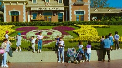 Guests pose around a topiary at the entrance to Disneyland Park in a photo from 1997.