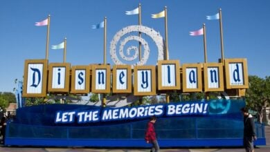 A "Let the memories begin sign" in the esplanade near the entrance to Disneyland Park and Disney California Adventure Park