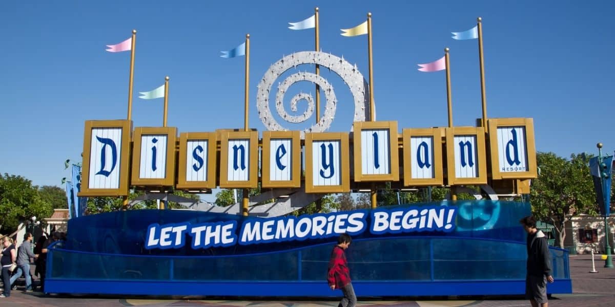 A "Let the memories begin sign" in the esplanade near the entrance to Disneyland Park and Disney California Adventure Park