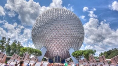Spaceship Earth in front of a cloudy blue sky at EPCOT.
