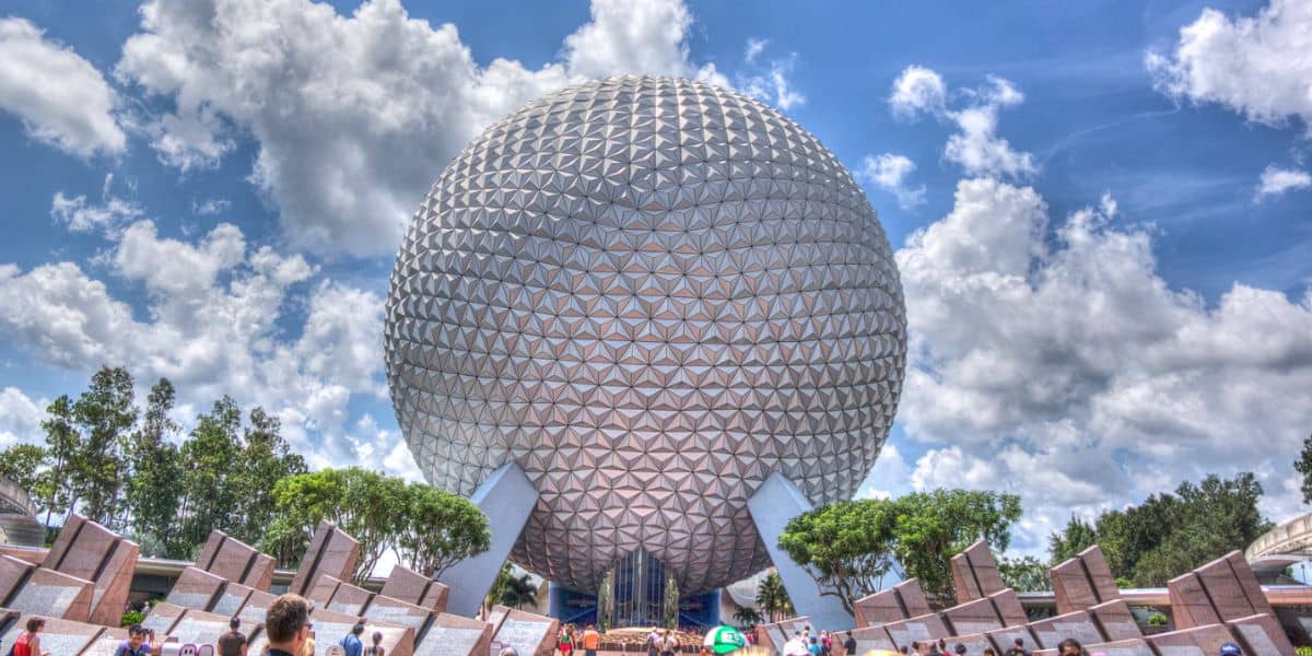 Spaceship Earth in front of a cloudy blue sky at EPCOT.