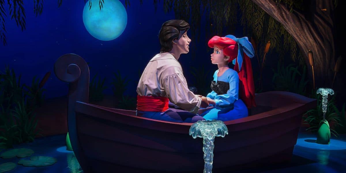 ariel and eric animatronics during 'kiss the girl' scene on little mermaid ride in disney park