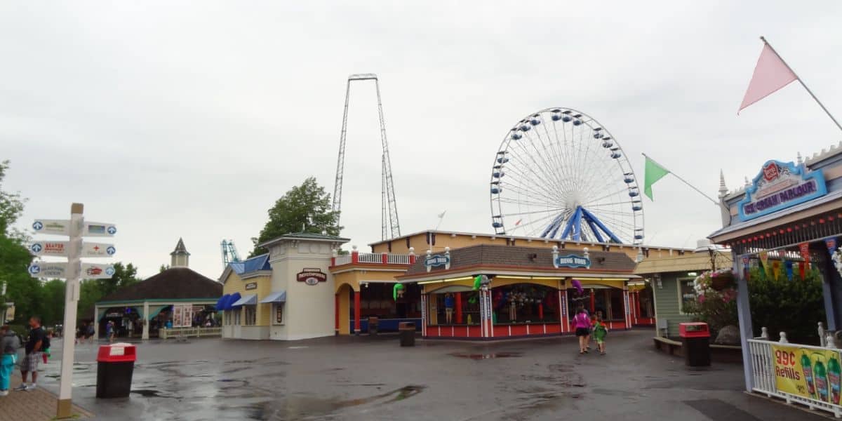 A guest area with carnival games and attractions at Six Flags Darien Lake.
