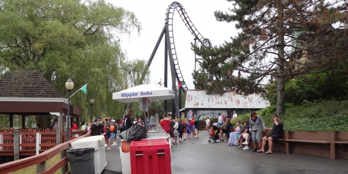 Guests walking near a Dippin Dots stand at Six Flags Darien Lake
