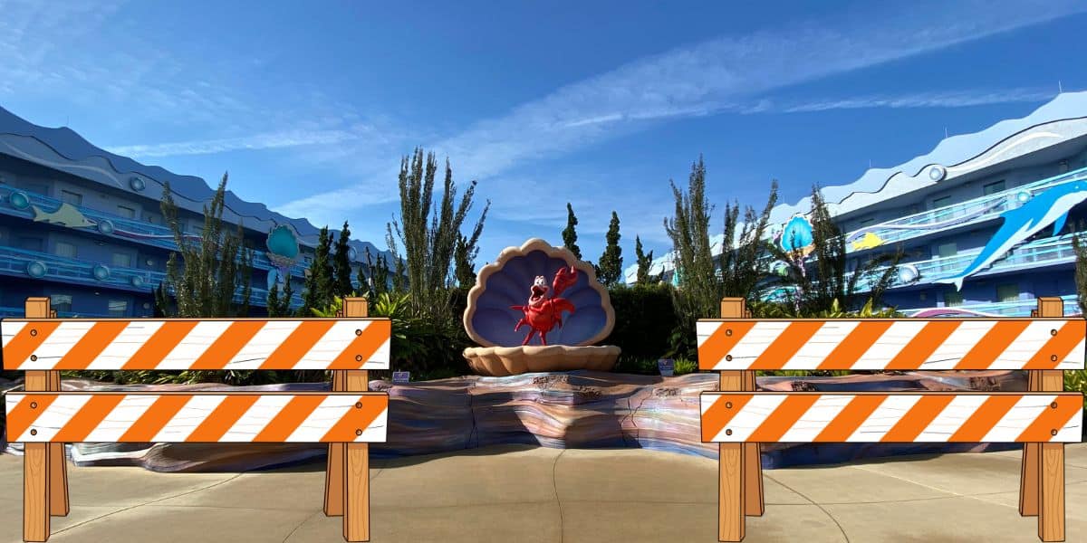 Sebastian the crab sculpture nestled in a shell with orange construction barriers out front, displayed outdoors at Disney’s Art of Animation Resort. The whimsical setup signals exciting refurbishments coming to this beloved Disney destination in 2027.